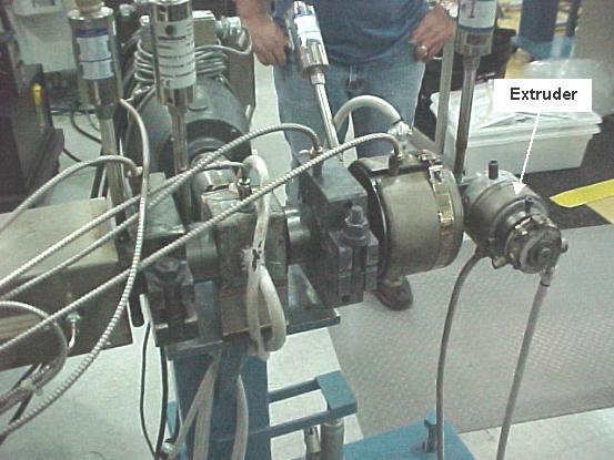 Ultrasonically agitated plastic extruder in a composite plastics production line